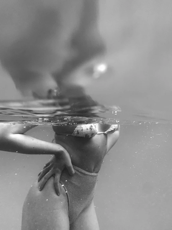 a woman is under the water looking at soing