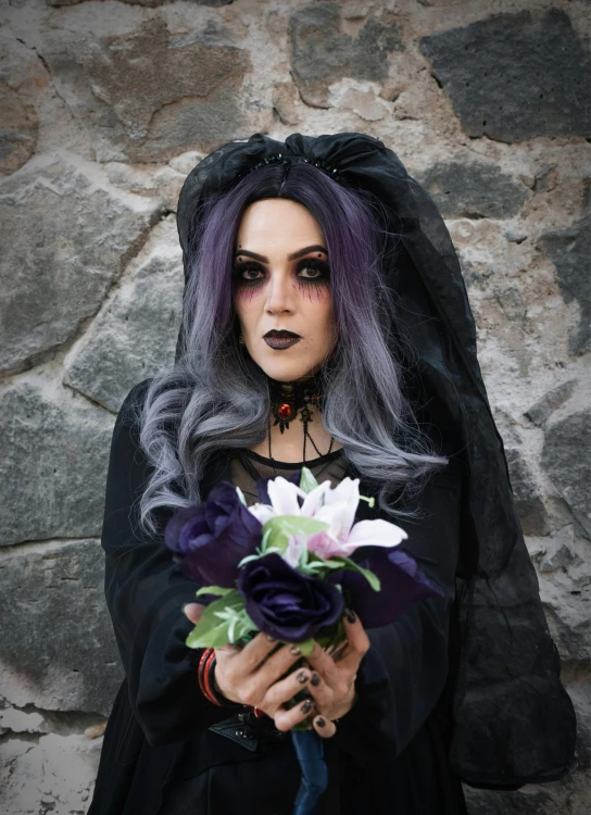 a woman with makeup holding a bouquet in her hands