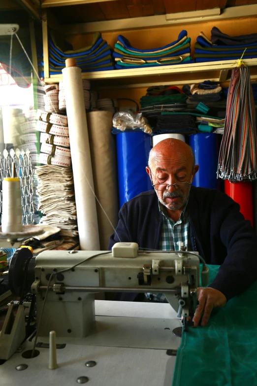 an elderly man working at a machine