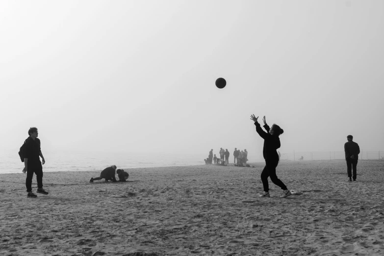 some people playing soccer on the beach