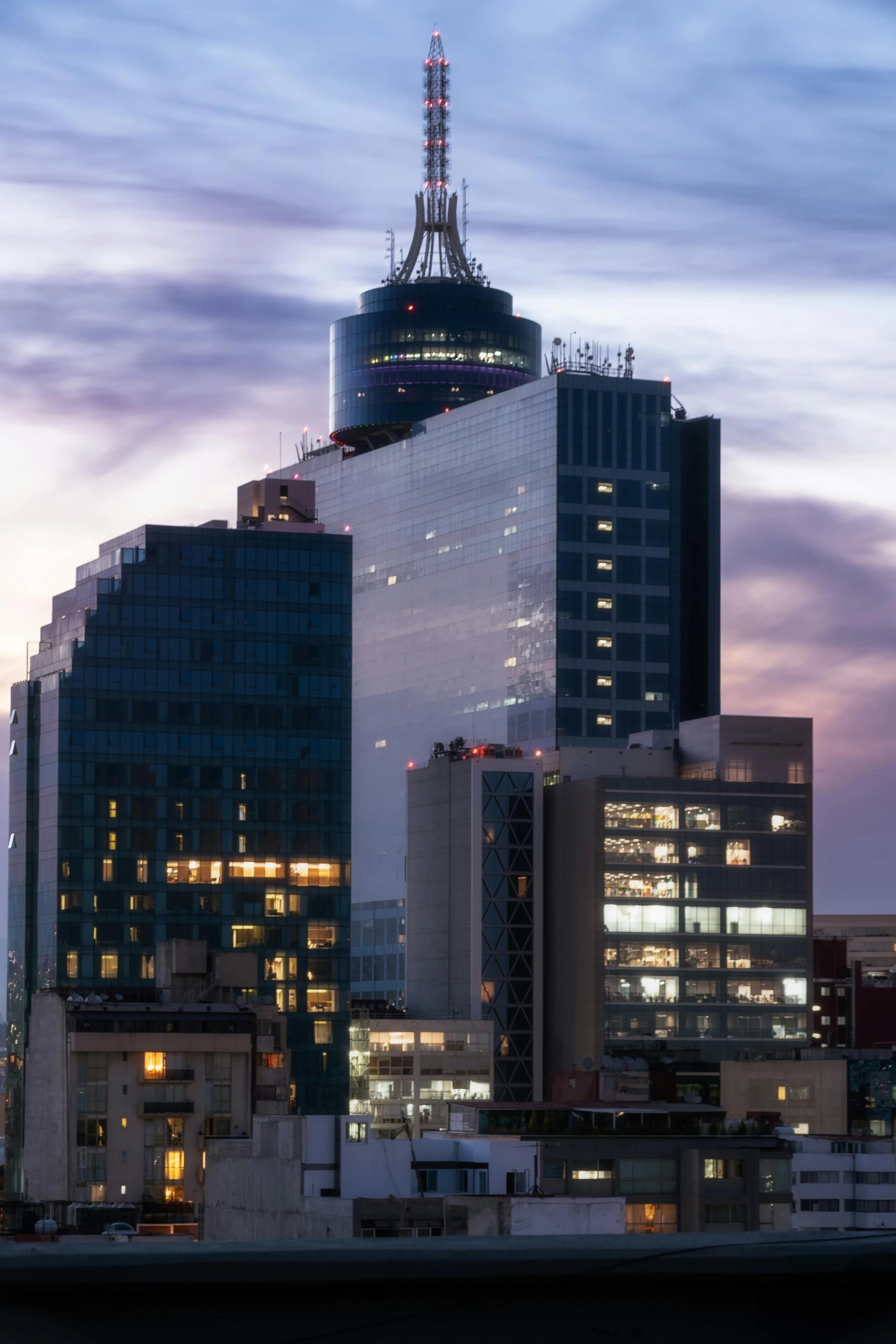 a very big building by some big buildings