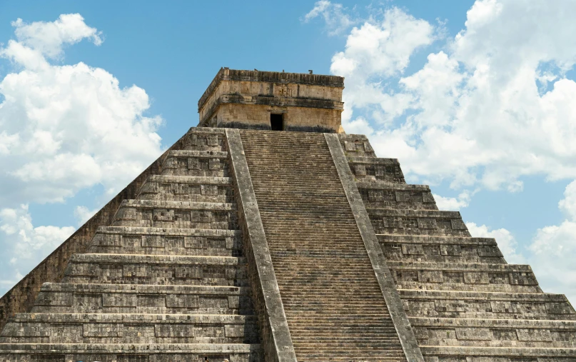 an unusual looking pyramid with two people on top