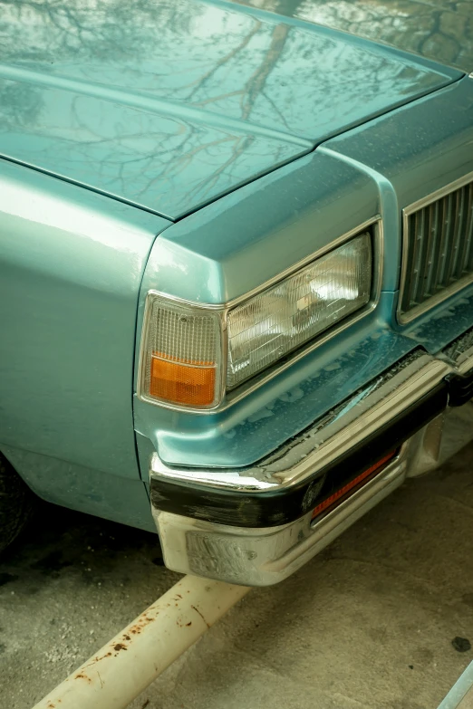 a light blue car is parked in a spot