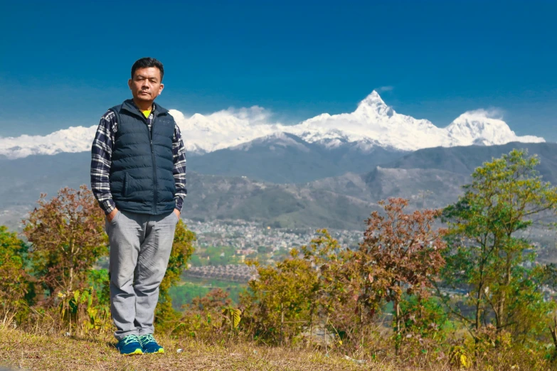 a man is standing on top of a hill