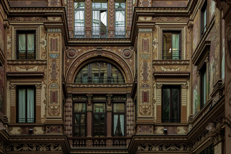 the outside of a large brown building with many windows