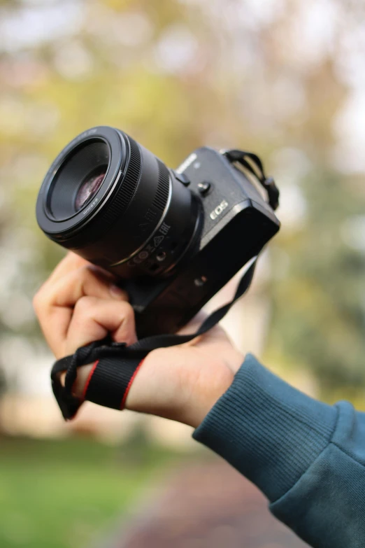 a person is holding a camera up to take a po