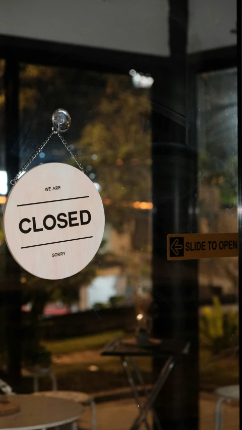 closed sign with chair in front of window