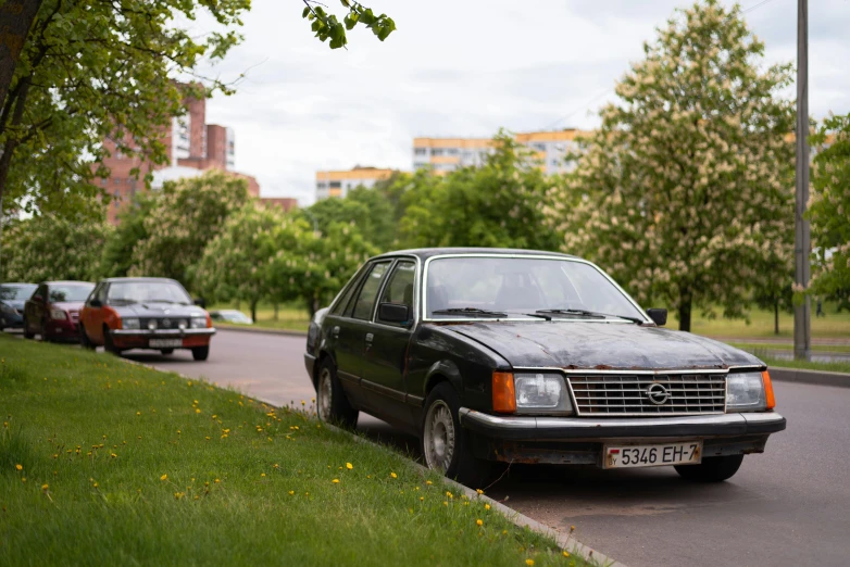 a small station wagon parked on the side of the road