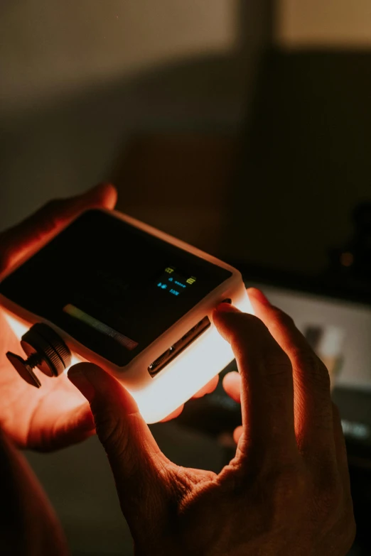 an illuminated phone in a persons hand with a flashlight