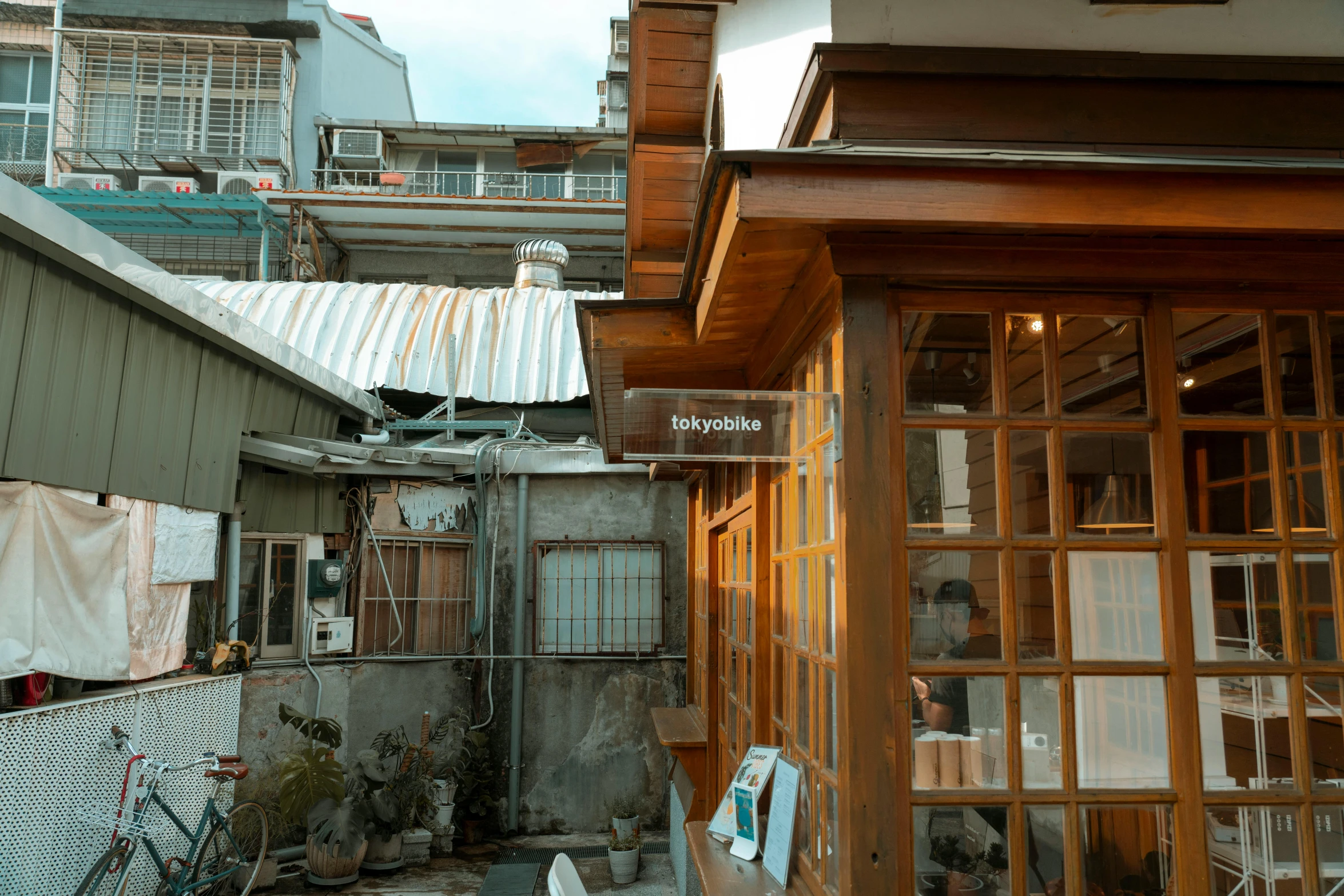 a narrow alley with a building and a lot of clothes