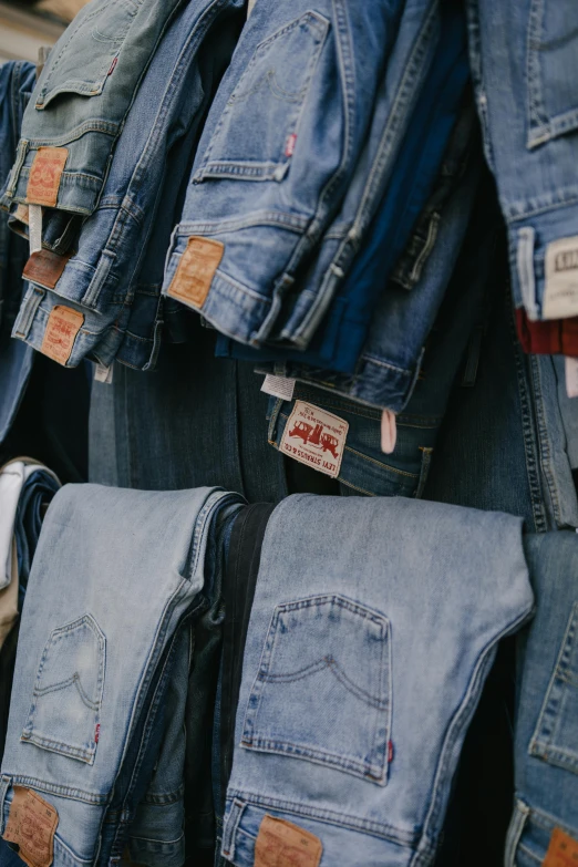 many jeans are hanging on the wall