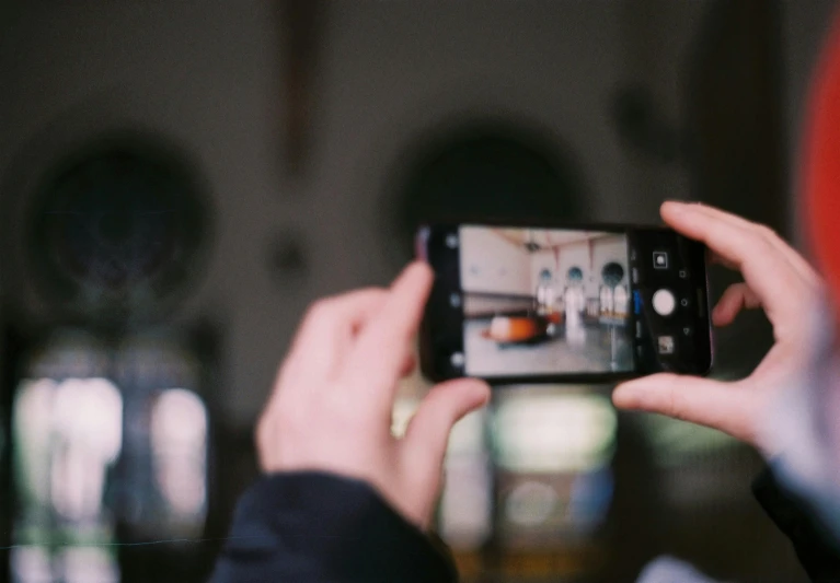 a woman holding up her phone to take a picture