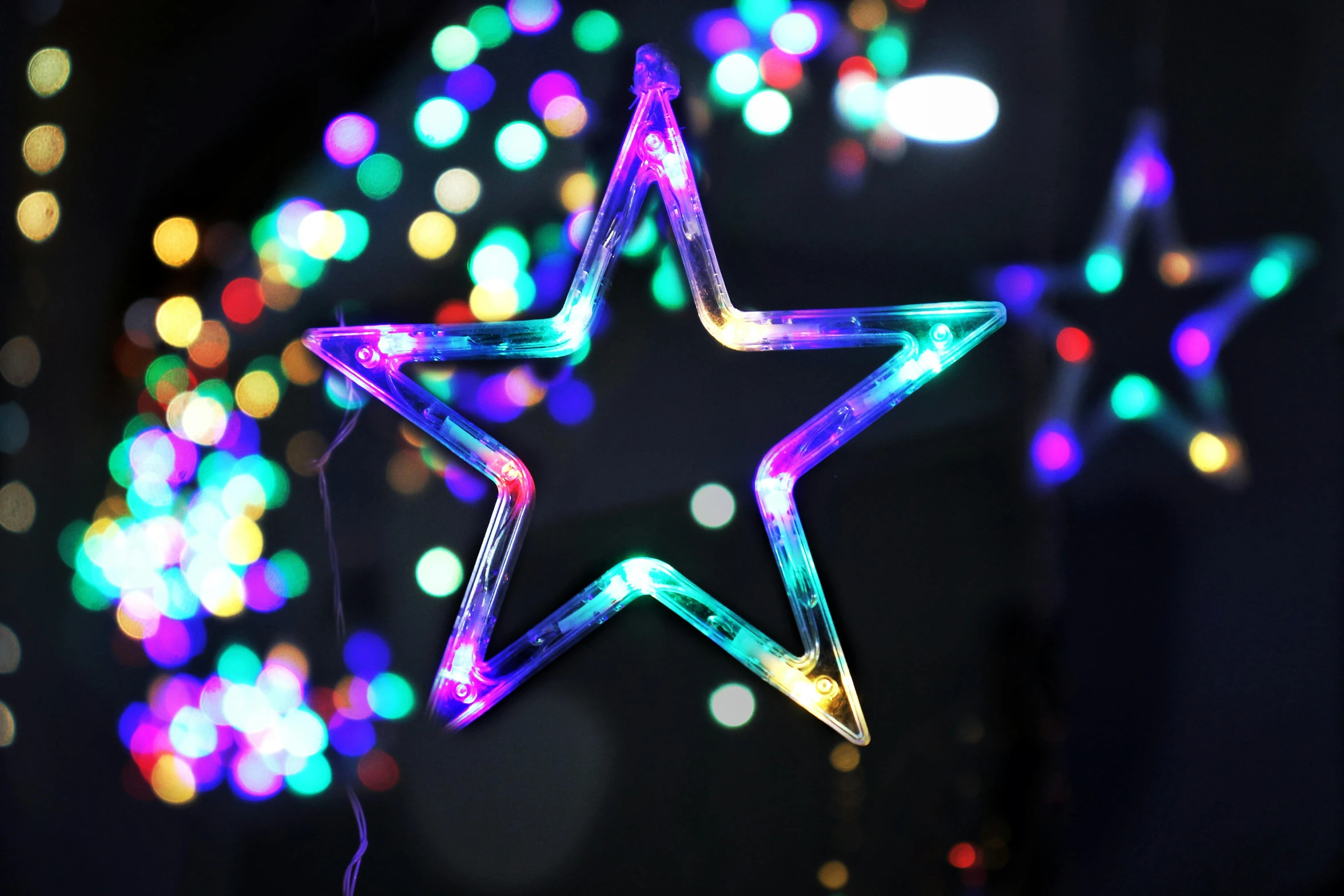 two bright star decorations hanging from the ceiling