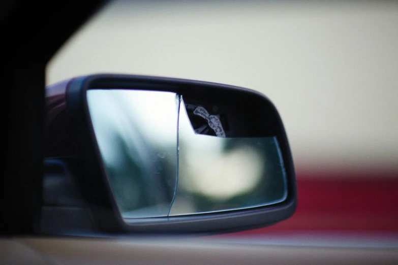 the side view mirror is being viewed with a stick