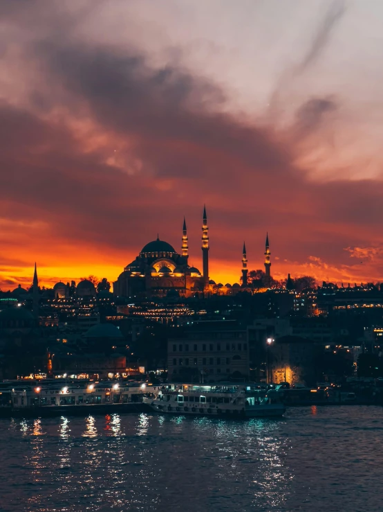 a very colorful sunset over some small and big buildings