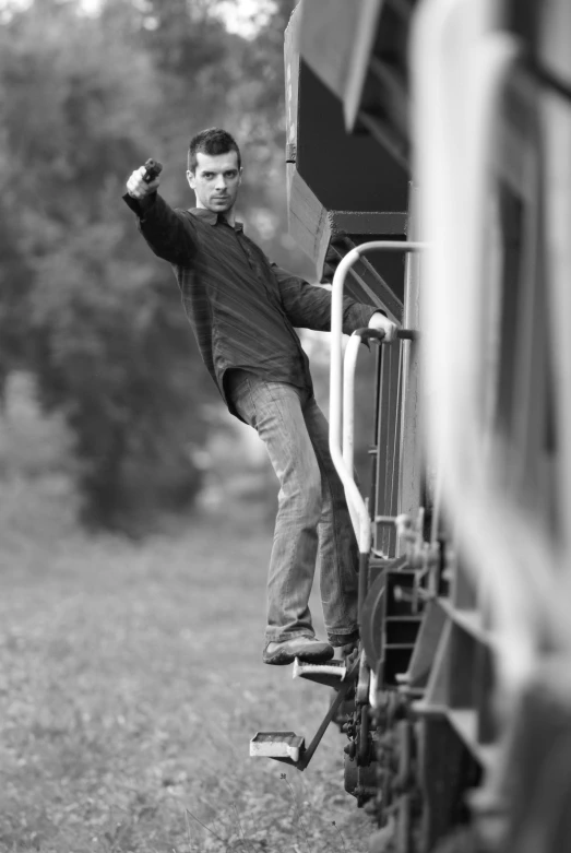 a black and white pograph of a man on a train