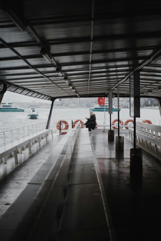 the interior of a covered boat traveling along a river