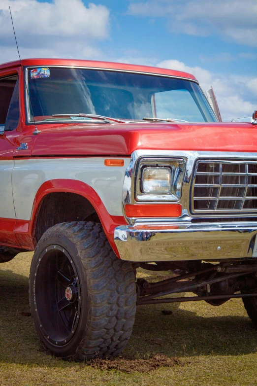 an orange and grey pickup truck is parked