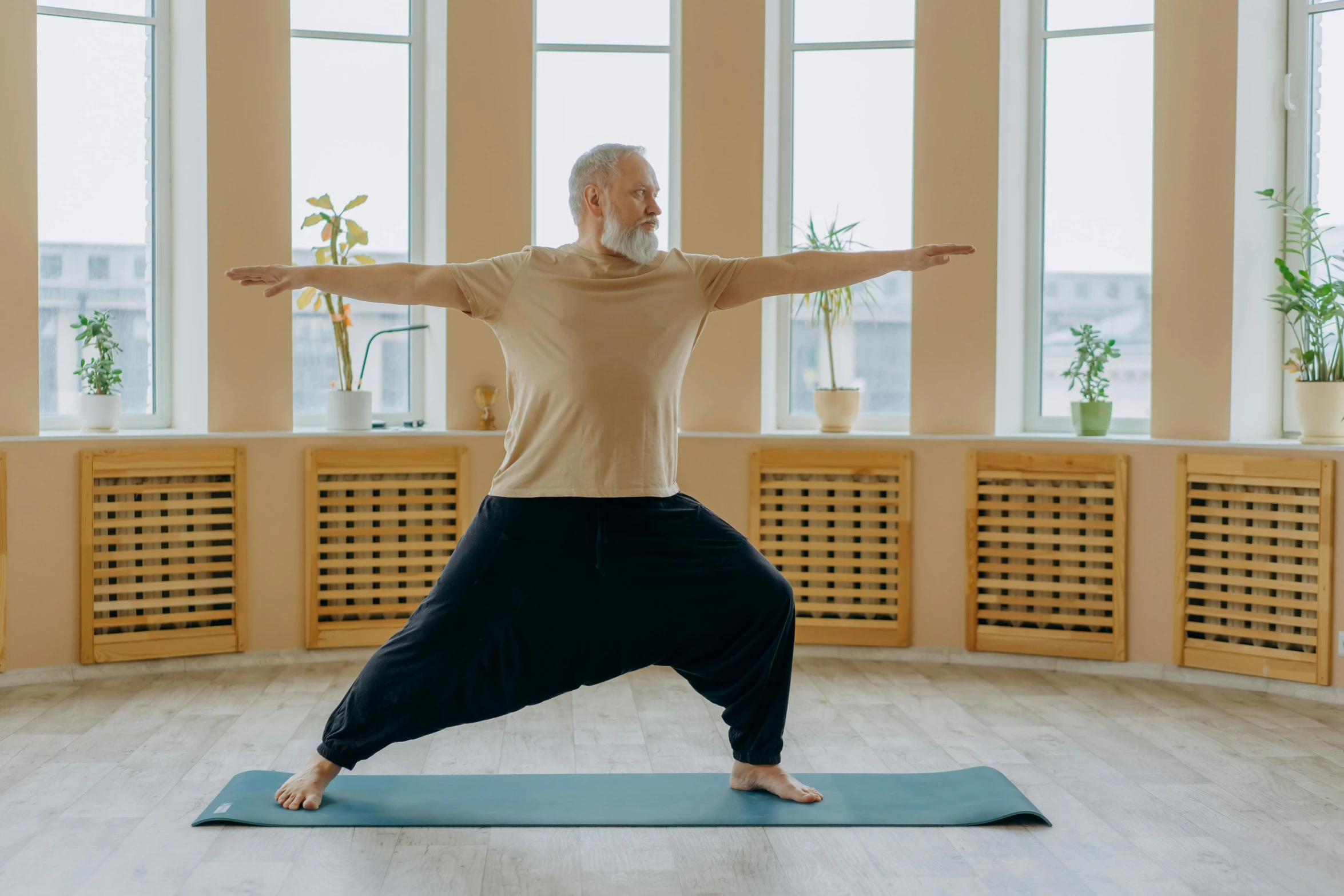 man doing yoga and standing on one leg