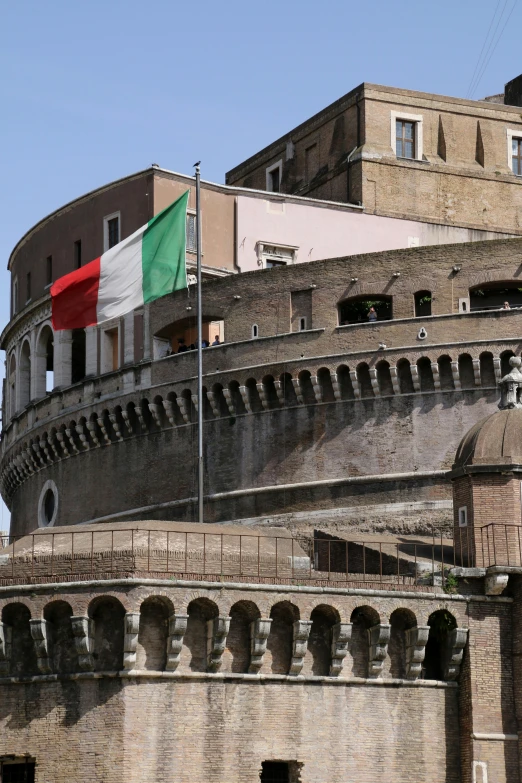 a green and white flag on top of a building