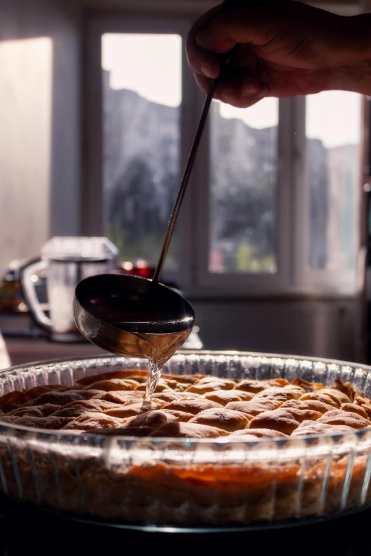 the pie is being prepared with a small scoop of glaze