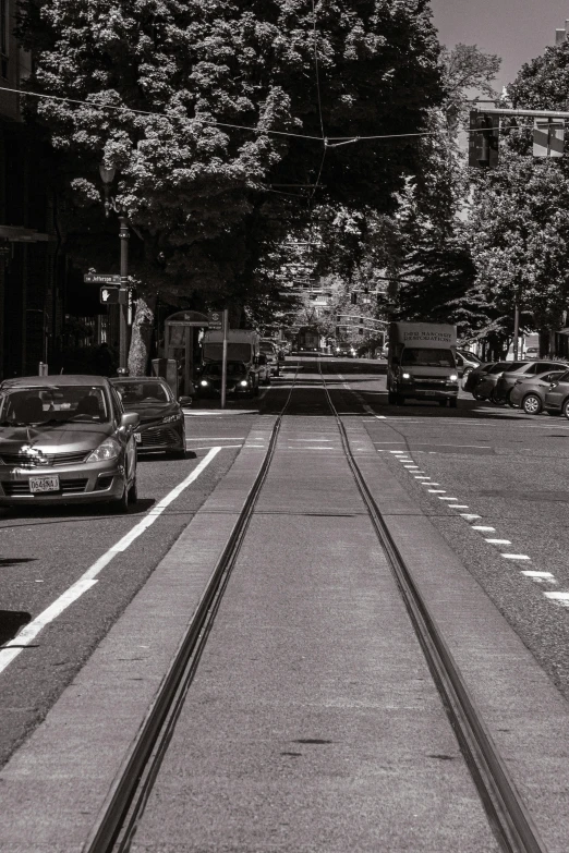 street cars sitting on the railroad tracks in the middle of a city