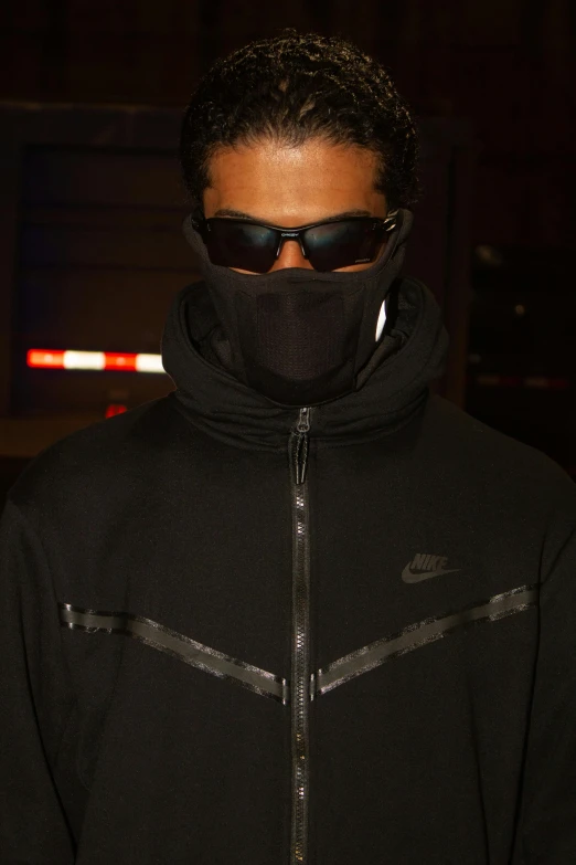 a person wearing a scarf and sunglasses on