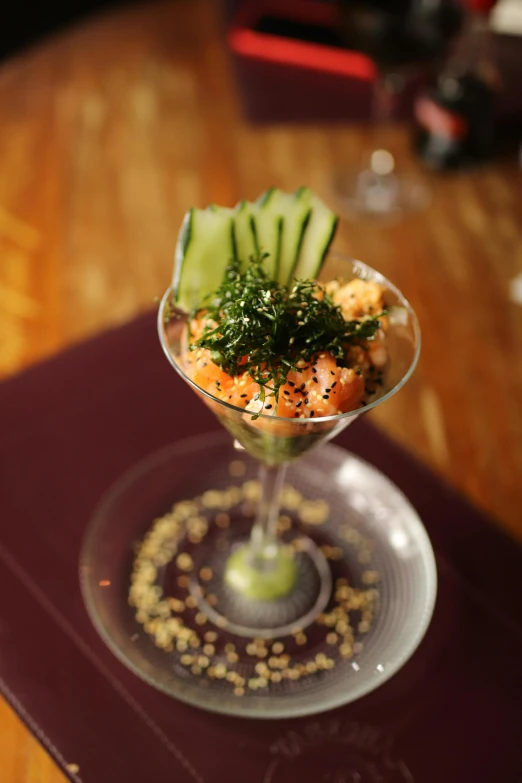 a table with a wine glass filled with a garnished food