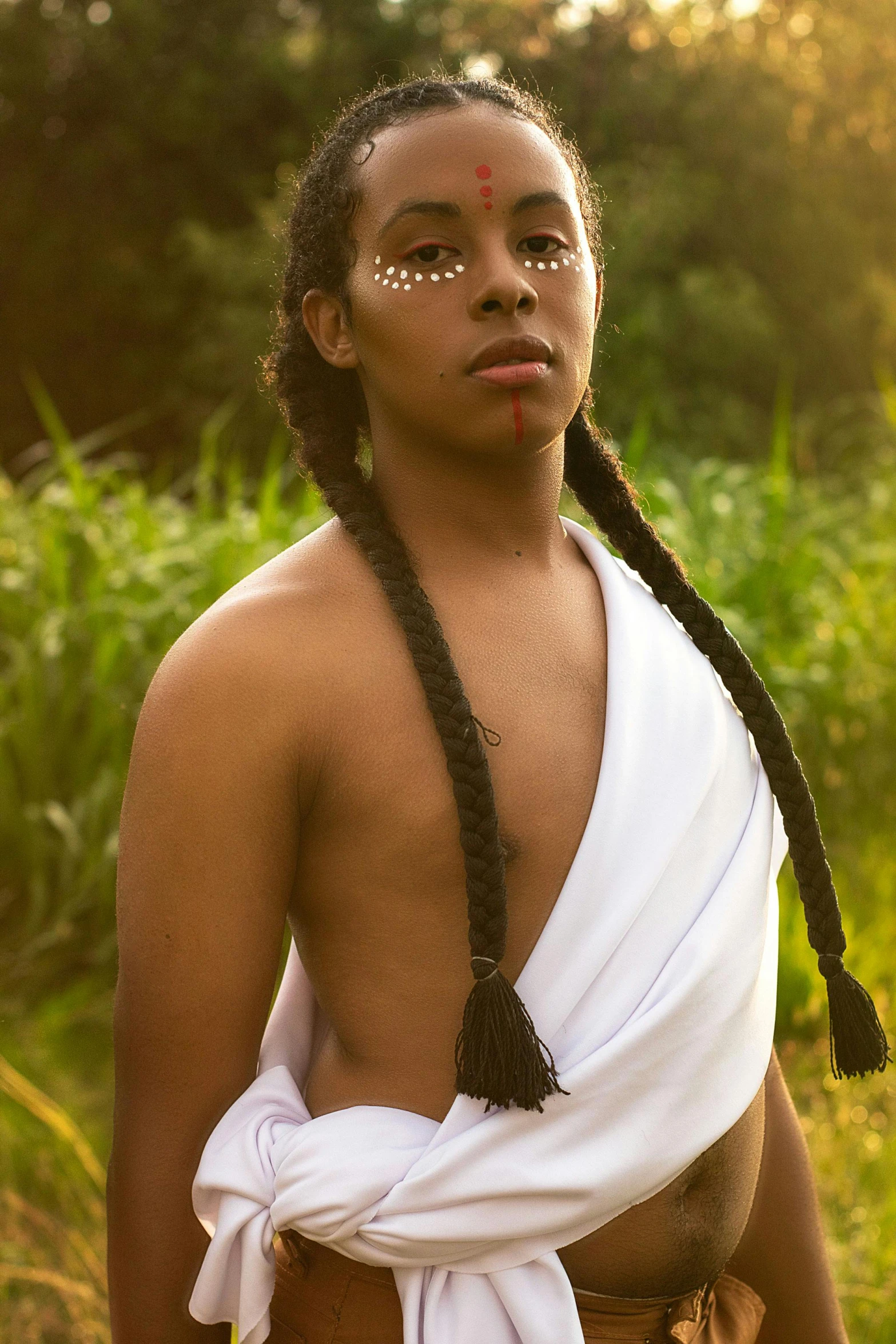 young indian man wearing white shirt in grassy area