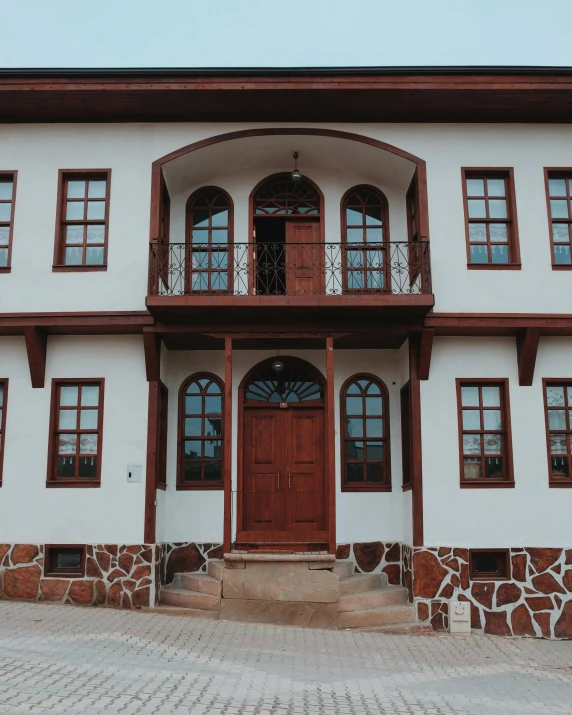 a large building with stone walkway next to it