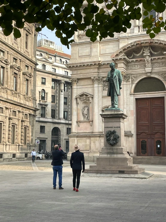 two people standing next to each other in a plaza