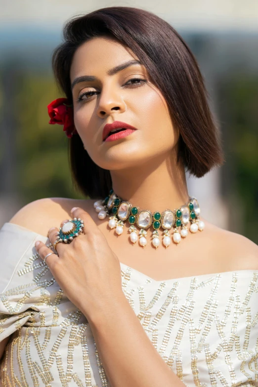 a beautiful woman holding onto some pearl jewelry