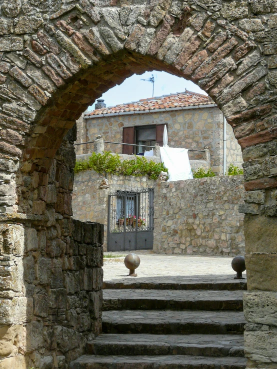 a couple of stone stairs leading up to a house