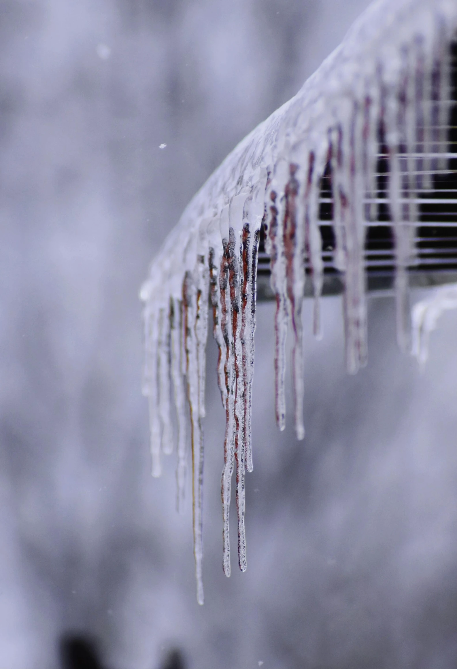 a gutter on the roof covered with ice and snow