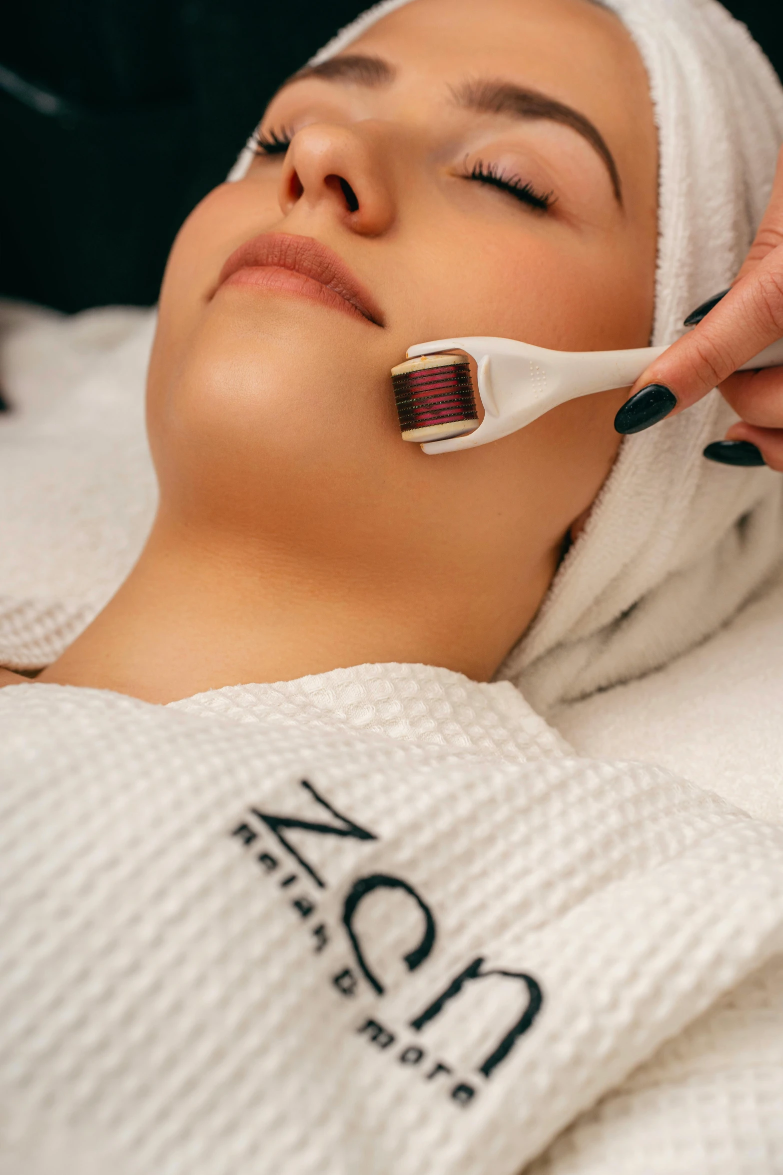 a woman lying down getting a facial peel on her eye