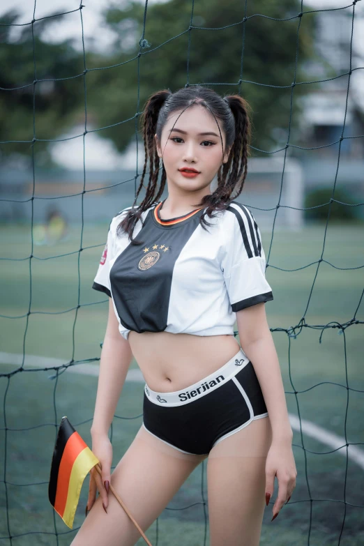 a girl is posing on a soccer field