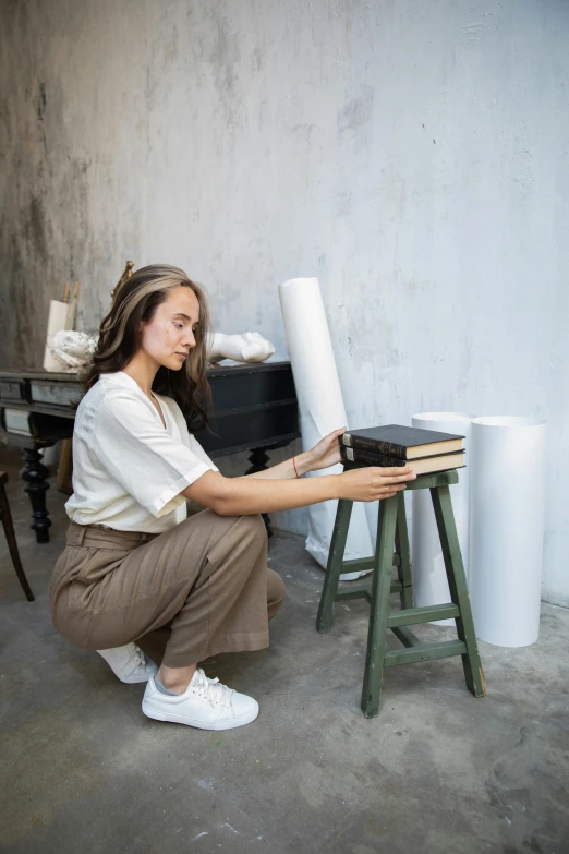 a  sits on the floor and assembling a plant on a small table