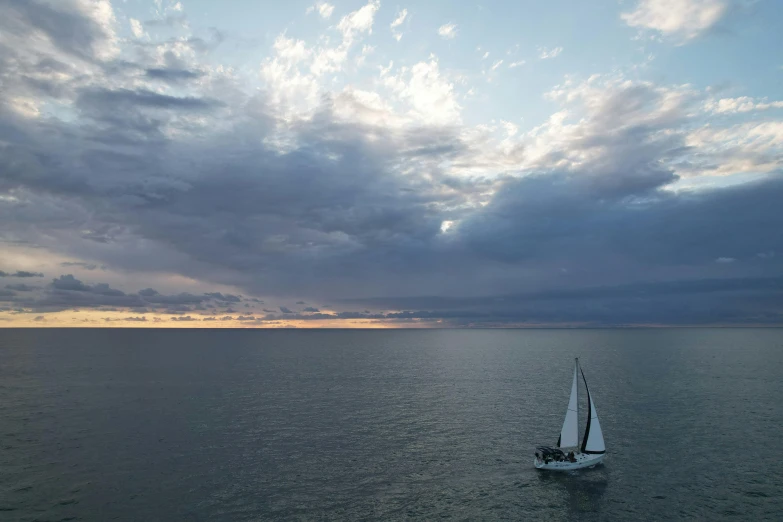 an empty sailboat is seen out in the open water