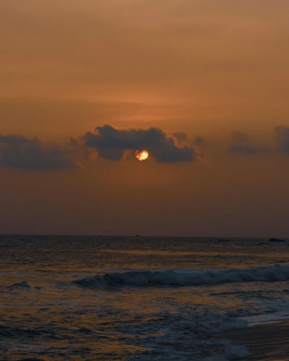 a sunset view of a sun over the ocean