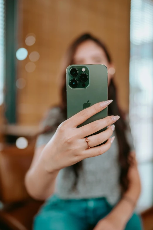 the woman is holding a smartphone with a camera attached