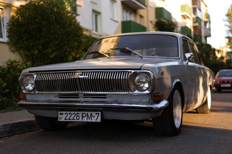 a car parked on a street with other cars in the background