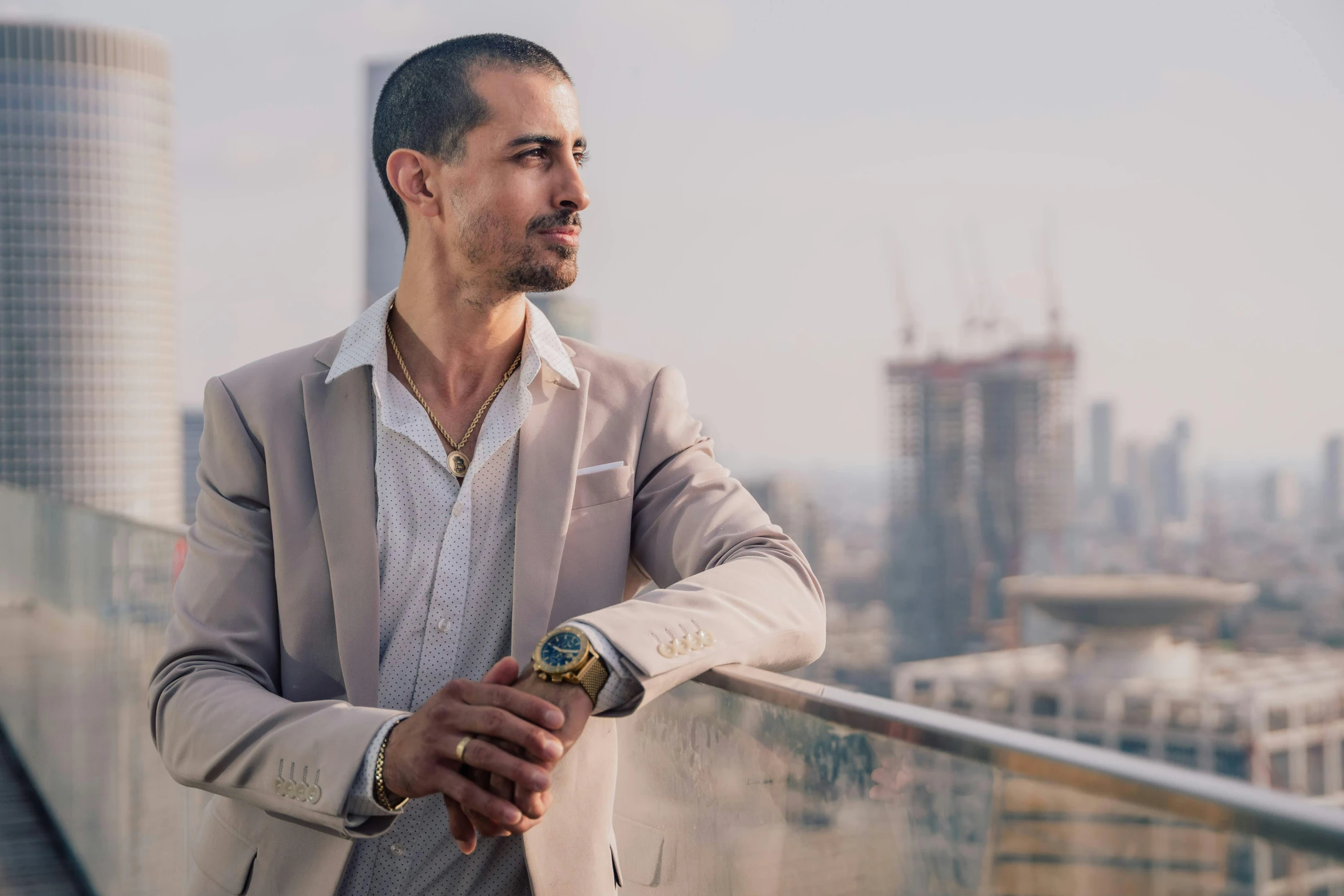 a man standing on top of a building near tall buildings