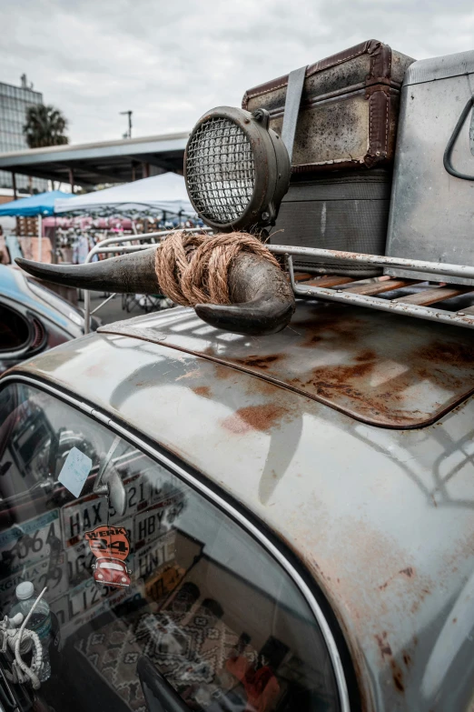 the old car has rust on the roof