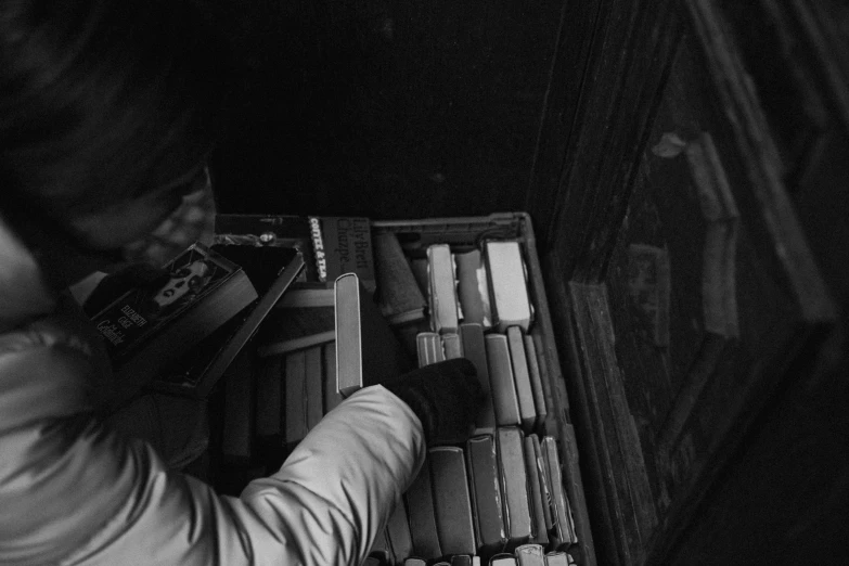 an older person reading in a book case