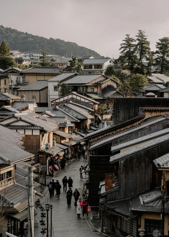 people are walking in the streets near houses