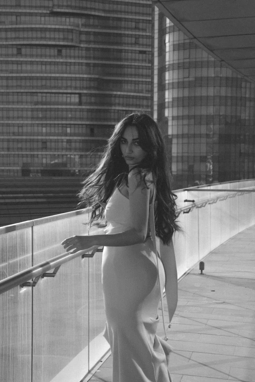 black and white pograph of woman on balcony looking off camera