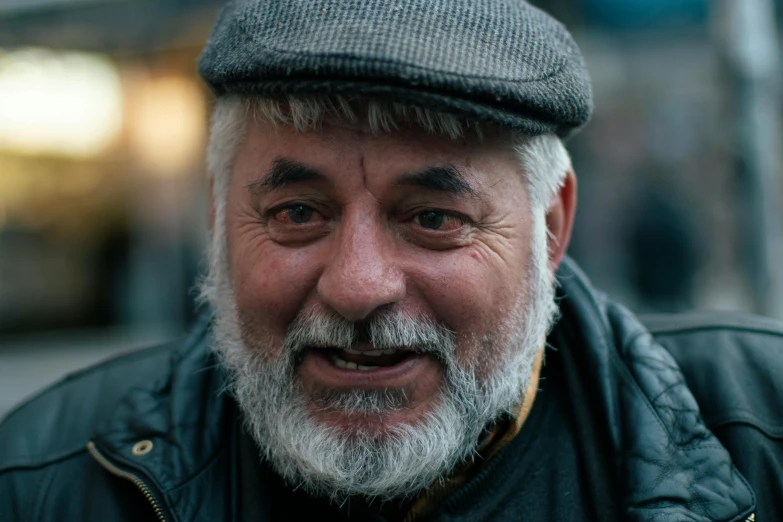 a man with a hat on, and an over - dyed gray beard