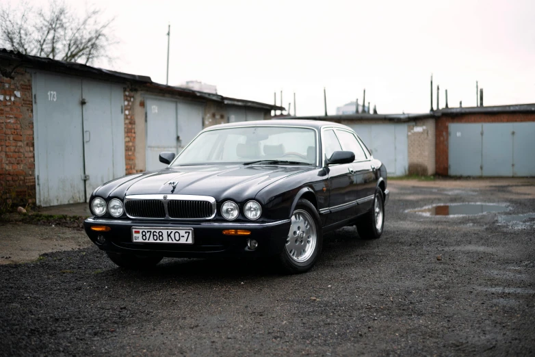 a black bmw with white headlights is parked