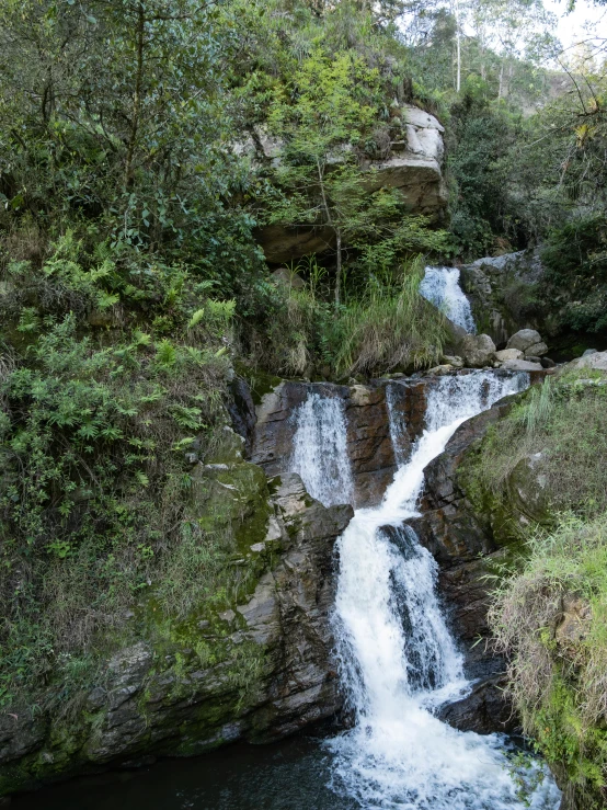 a small waterfall with lots of water flowing down it