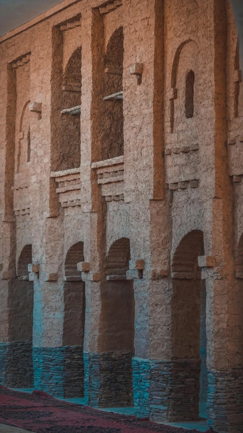 a row of pillars are reflected on water